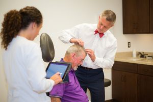 dermatologist examining patient